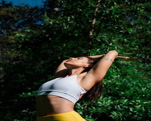 Woman practicing yoga outdoors in nature
